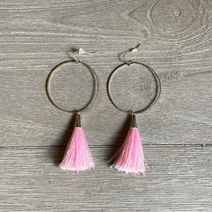 Gold hoop earrings with dangling pink frills.